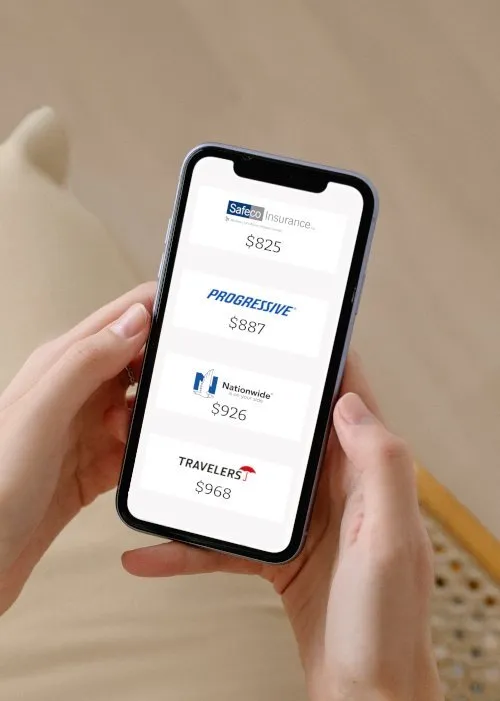Person holding smartphone with comparison of insurance quotes on screen